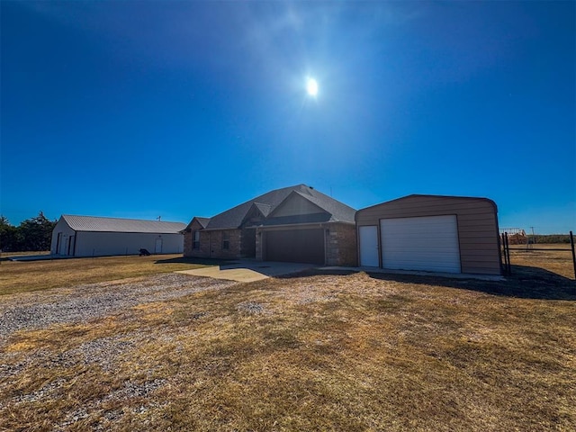 single story home with a garage and a front lawn