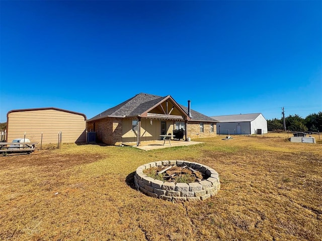 back of house featuring a lawn, a patio area, and central AC unit