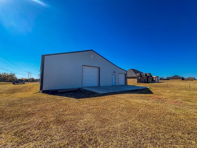 garage featuring a lawn