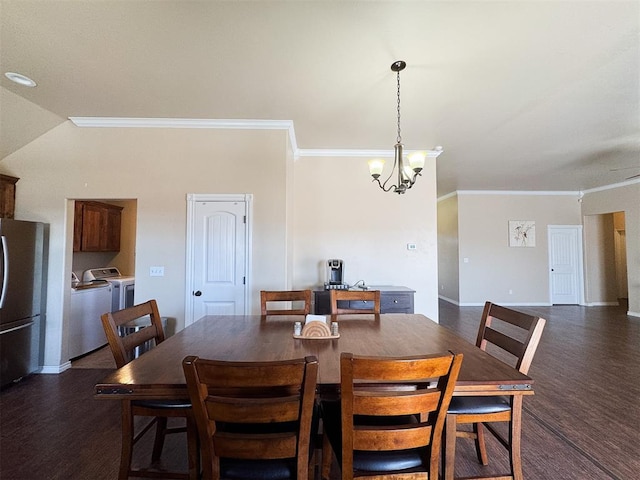 dining room with a chandelier, dark hardwood / wood-style flooring, washing machine and dryer, and crown molding