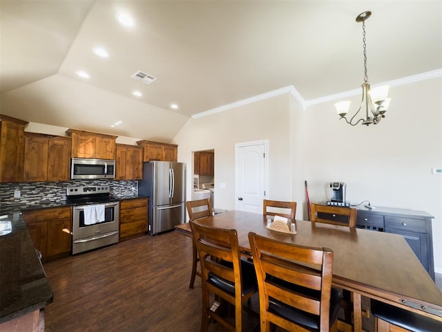 kitchen featuring hanging light fixtures, dark hardwood / wood-style floors, decorative backsplash, appliances with stainless steel finishes, and a notable chandelier