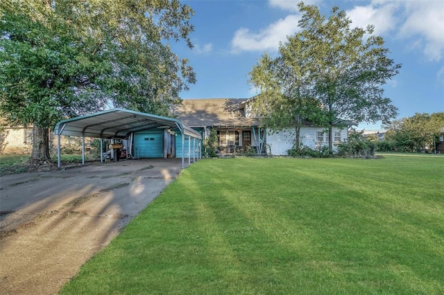 view of front of house with a carport, a garage, and a front yard