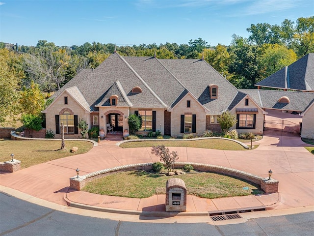 french country style house with a front lawn