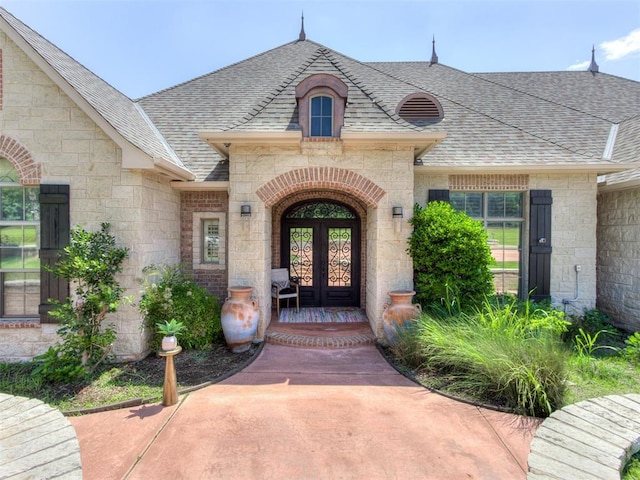 view of exterior entry featuring french doors