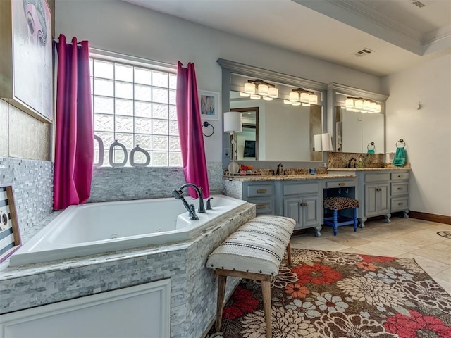 bathroom featuring tile patterned floors, crown molding, vanity, and a relaxing tiled tub