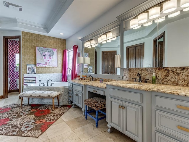 bathroom with backsplash, a tub, vanity, and ornamental molding