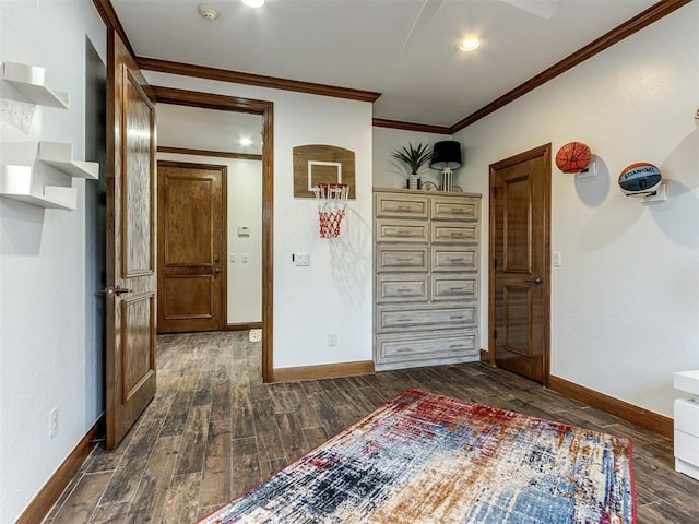 empty room featuring ornamental molding and dark wood-type flooring