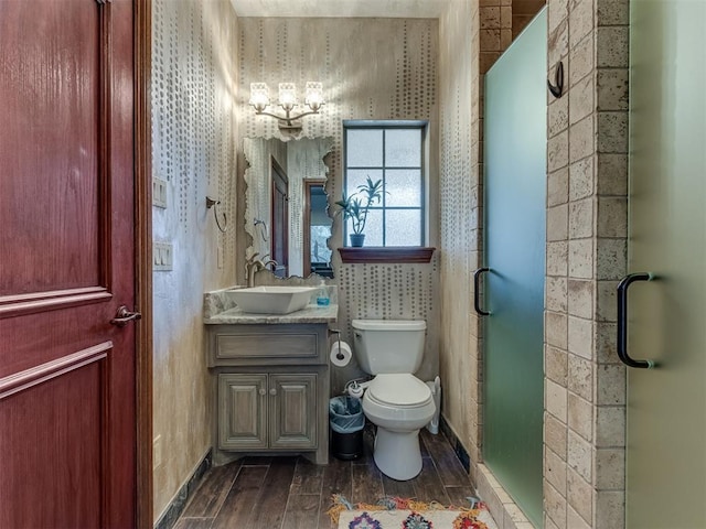 bathroom featuring toilet, hardwood / wood-style floors, vanity, and walk in shower