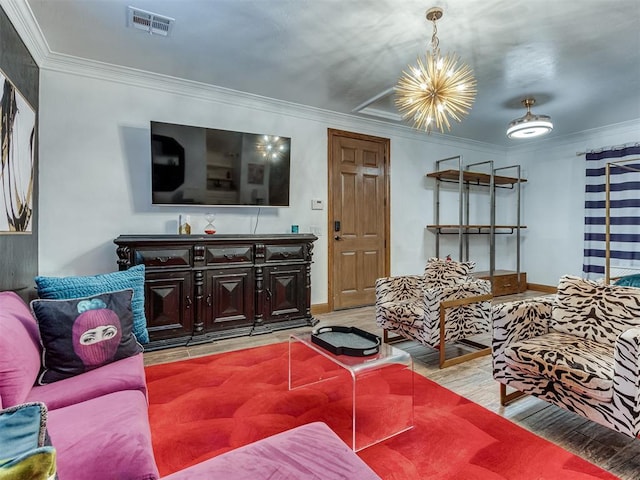 living room with a chandelier, light wood-type flooring, and ornamental molding