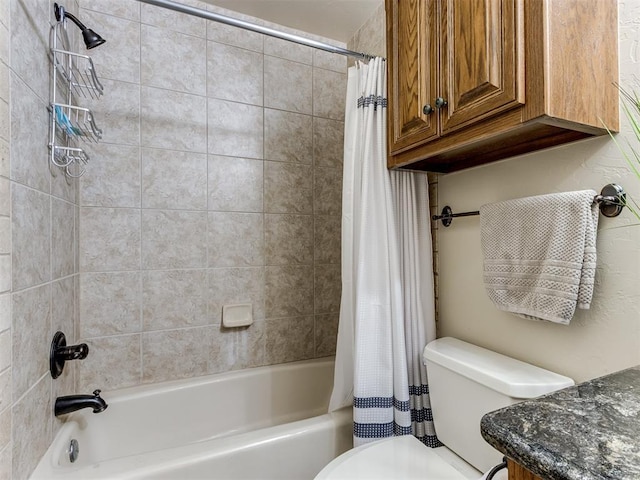 bathroom featuring shower / tub combo and toilet