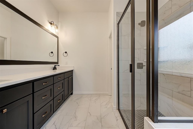 bathroom featuring double vanity, baseboards, marble finish floor, a shower stall, and a sink