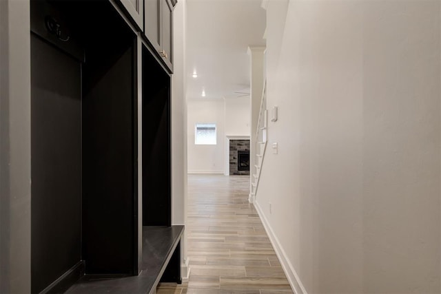 corridor featuring wood finish floors and baseboards