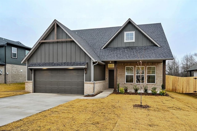 craftsman-style home featuring a garage and a front lawn