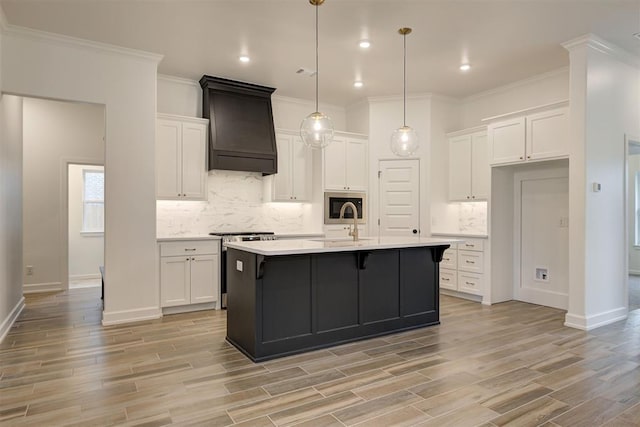 kitchen with white cabinets, light wood-style floors, custom range hood, light countertops, and stainless steel range with electric stovetop