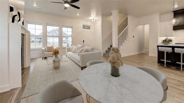 2348 Ridge Pine Rd, Edmond, OK 73034 - living room with a ceiling fan, light wood-style floors, stairs, crown molding, and recessed lighting