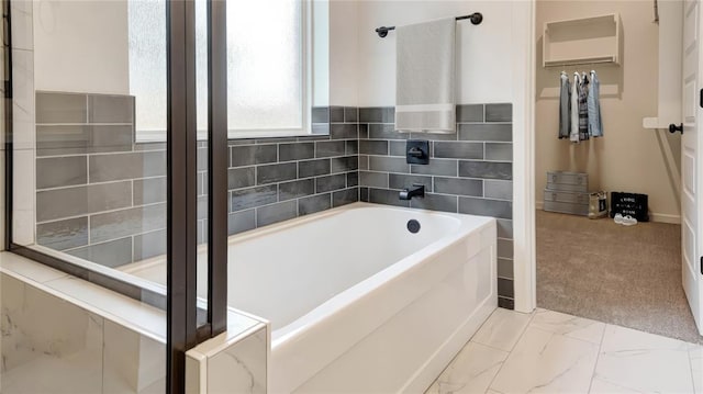 2348 Ridge Pine Rd, Edmond, OK 73034 - bathroom with a bath and marble look tile flooring