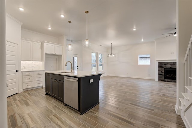 2348 Ridge Pine Rd, Edmond, OK 73034 - kitchen with dishwasher, open floor plan, light countertops, ornamental molding, and ceiling fan