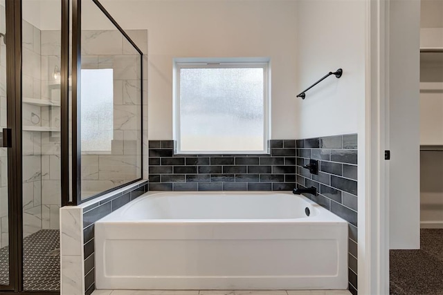 2348 Ridge Pine Rd, Edmond, OK 73034 - full bathroom featuring a bath, a shower stall, and a walk in closet