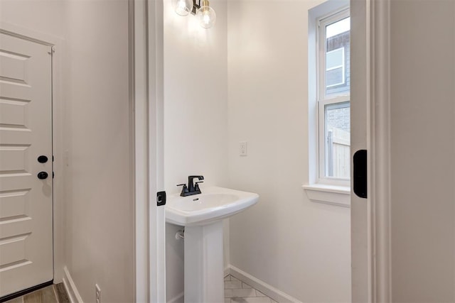 2348 Ridge Pine Rd, Edmond, OK 73034 - bathroom featuring baseboards and a sink