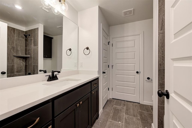 2348 Ridge Pine Rd, Edmond, OK 73034 - bathroom featuring vanity and a tile shower