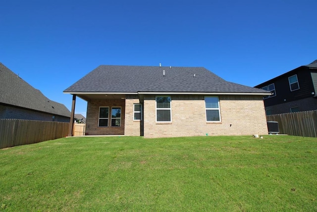 2348 Ridge Pine Rd, Edmond, OK 73034 - rear view of property with a fenced backyard, brick siding, and a shingled roof