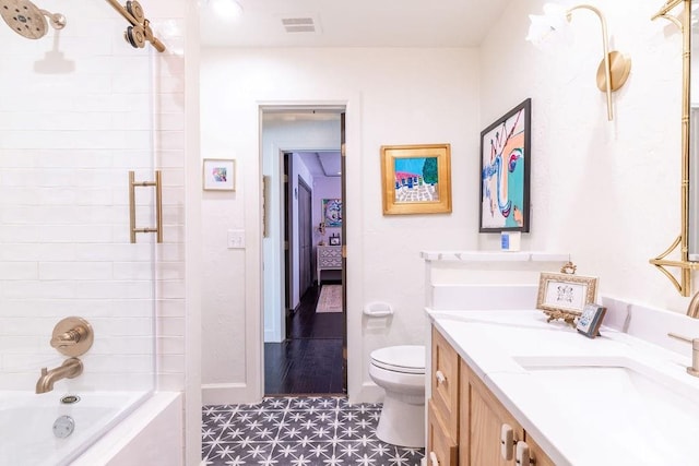 full bathroom featuring vanity, toilet, and bath / shower combo with glass door