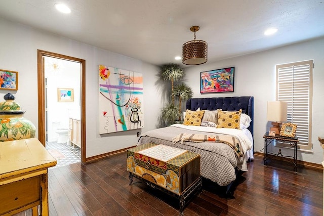 bedroom with dark hardwood / wood-style floors and ensuite bathroom