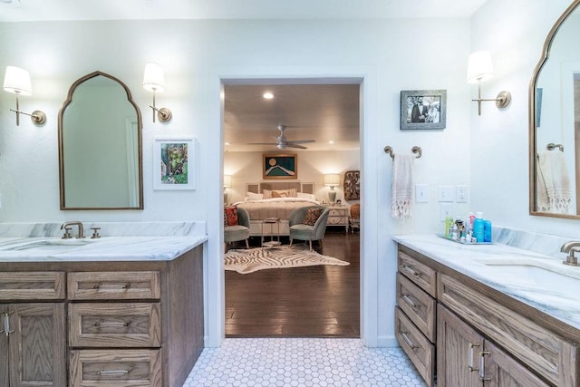 bathroom featuring wood-type flooring, vanity, and ceiling fan