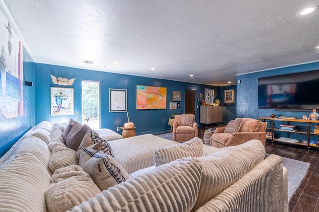 living room with dark hardwood / wood-style flooring, baseboard heating, and a textured ceiling