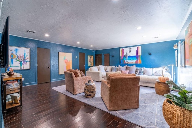 living room with wood-type flooring and a textured ceiling