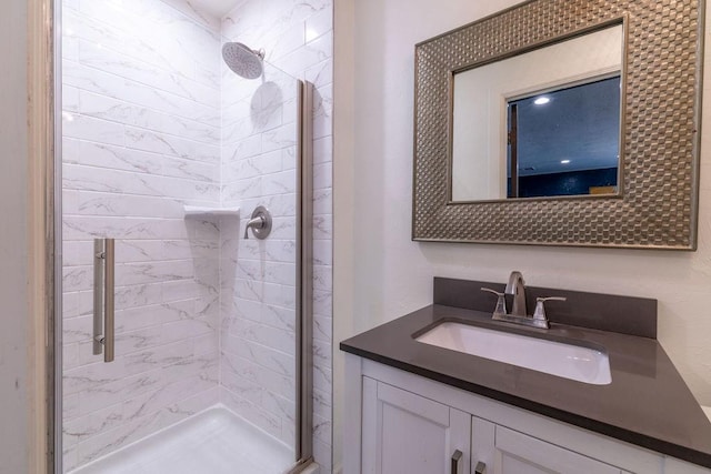 bathroom with vanity and a shower with shower door