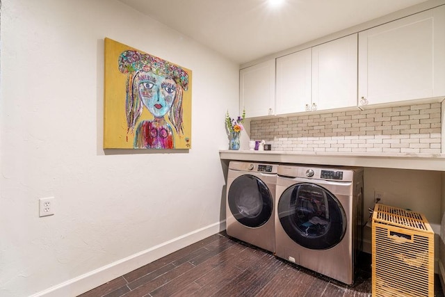 clothes washing area with cabinets, dark hardwood / wood-style flooring, and separate washer and dryer