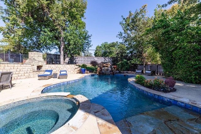 view of pool with a patio area and an in ground hot tub