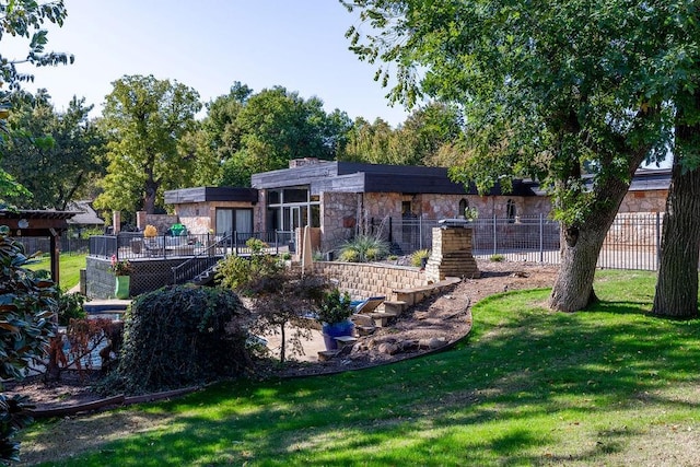 rear view of house with a lawn and a deck