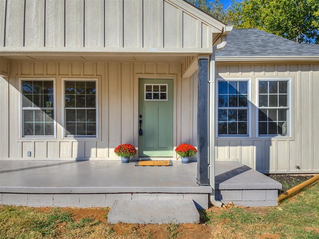 view of exterior entry with a porch