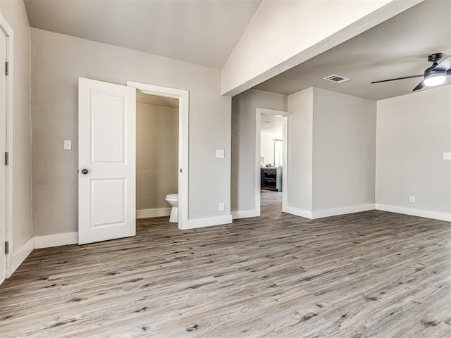 unfurnished bedroom featuring ensuite bathroom, ceiling fan, and light hardwood / wood-style flooring