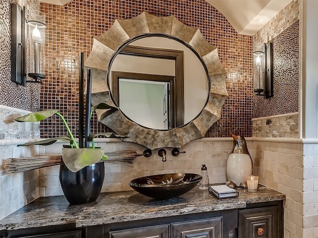 bathroom with vanity, tile walls, and tasteful backsplash