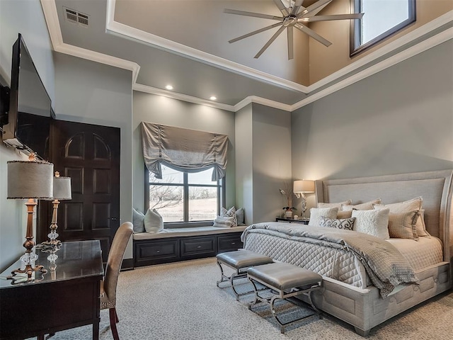 carpeted bedroom featuring a high ceiling, ceiling fan, and ornamental molding