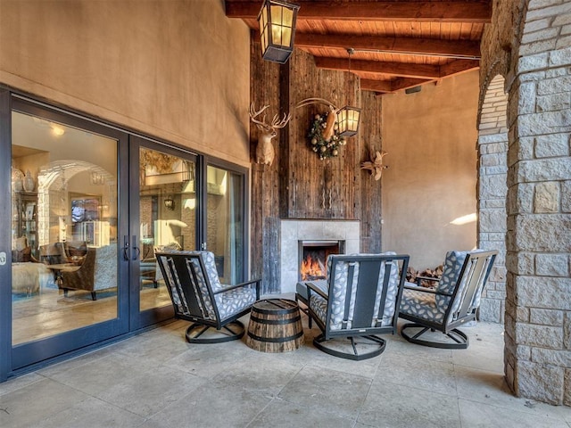 view of patio with a fireplace and french doors