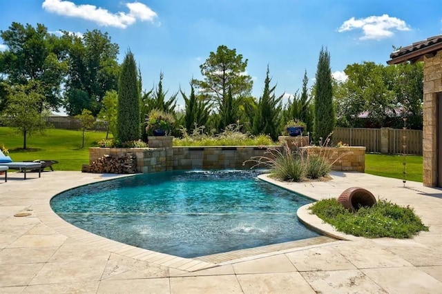 view of pool with pool water feature, a yard, and a patio