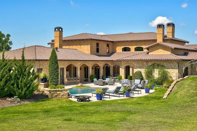 rear view of house with an outdoor hangout area, a patio area, and a lawn