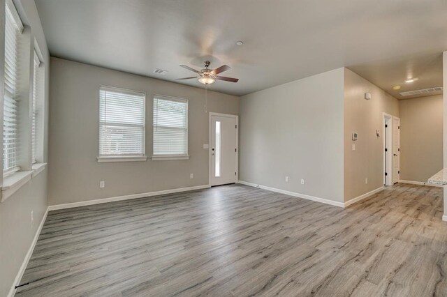 unfurnished room with light hardwood / wood-style floors and ceiling fan