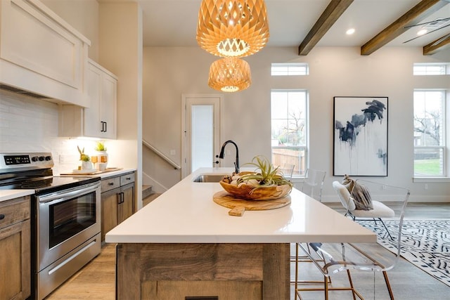 kitchen featuring a wealth of natural light, sink, hanging light fixtures, beamed ceiling, and stainless steel electric range