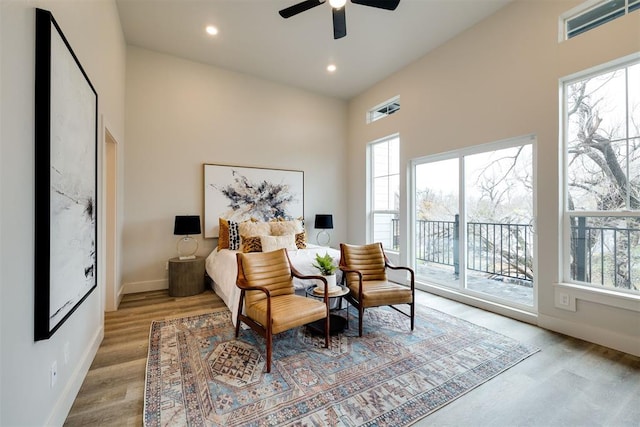 bedroom with ceiling fan, light wood-type flooring, access to outside, and multiple windows