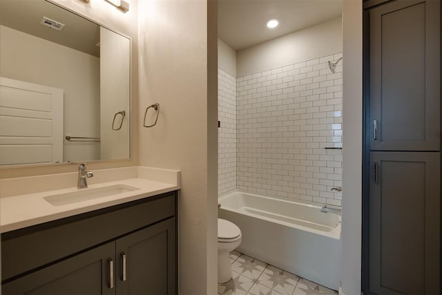 full bathroom with vanity, toilet, and tiled shower / bath