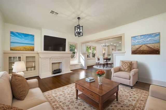 living room with hardwood / wood-style flooring and a notable chandelier