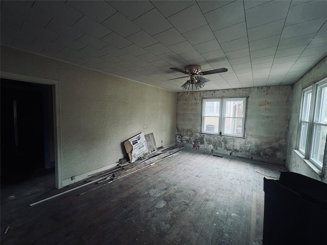 unfurnished room with ceiling fan and hardwood / wood-style flooring