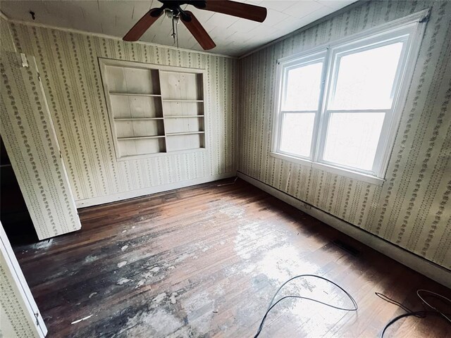 interior space featuring wood-type flooring, built in features, and ceiling fan