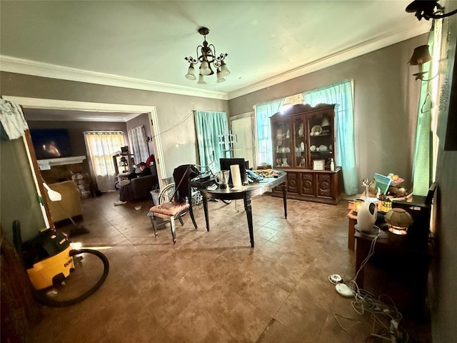 interior space featuring a fireplace, a healthy amount of sunlight, a notable chandelier, and ornamental molding