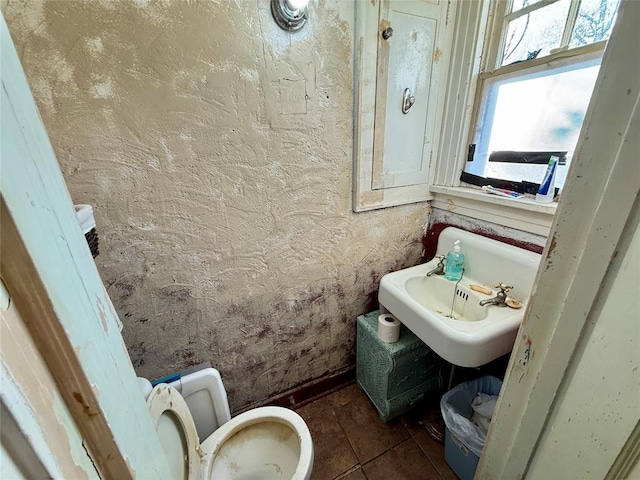 bathroom with tile patterned flooring, toilet, and sink